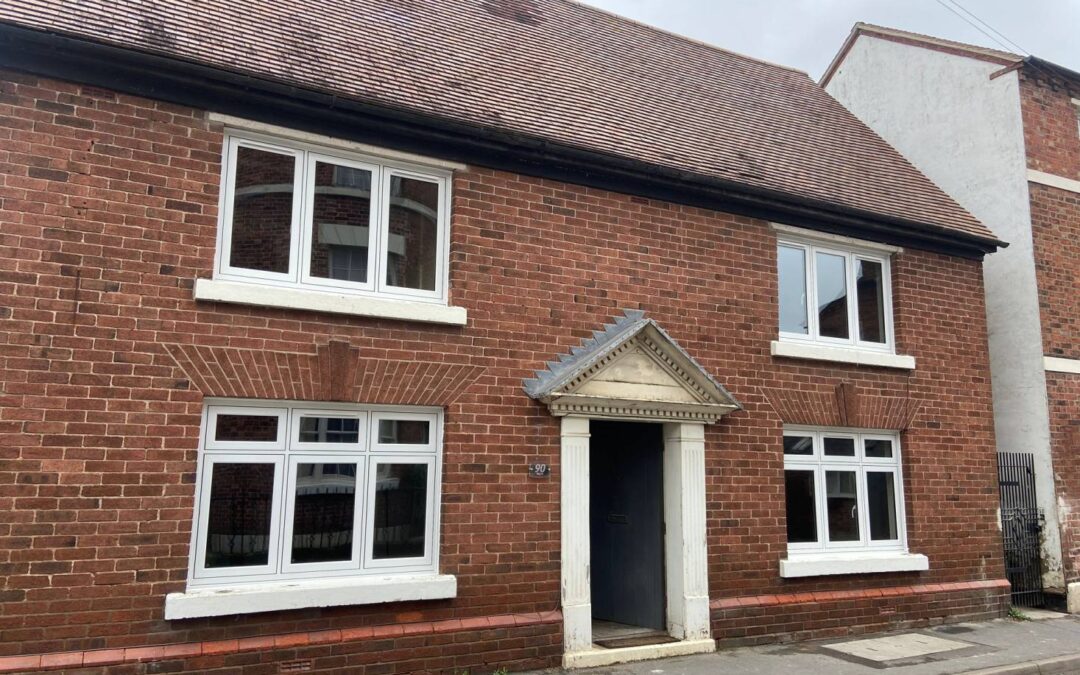 A sliding glass door being installed in a living room.